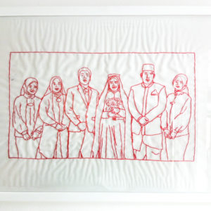 Ibu Dwi Restu's final framed embroidery of her family. It features six figures standing in a line next to each other.