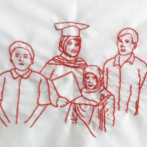 Ibu Suyanah's final embroidery of her family. It features four figures standing together. The middle figure has a graduation cap on and is holding a diploma. She looks happy. She is surrounded by a young boy and a young girl and a man.