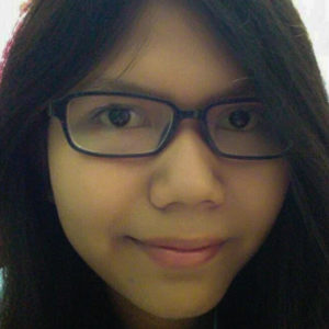 Ibu Diah's daughter, a close up of her face. She is wearing glasses and has dark hair.